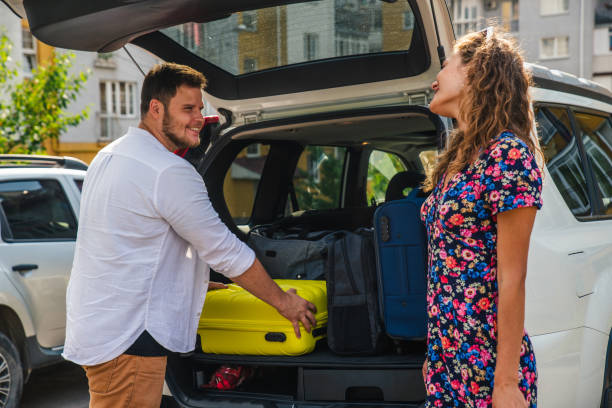 istock couple put bags in car trunk 1053329216