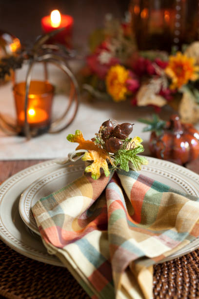 istock Autumn Thanksgiving dining table place setting on an old rustic wood rustic table 1053335746