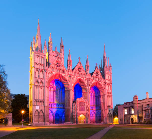 Peterborough Cathedral Illuminated at Sunset, United Kingdom Last of the Sunlight Glow on the Facade cambridgeshire photos stock pictures, royalty-free photos & images