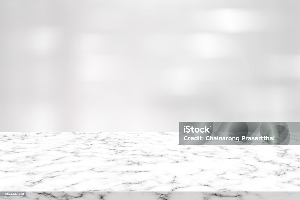 abstract blur clean white color interior contemporary office background with marble plank counter table for promote and show content or product on display Marble - Rock Stock Photo