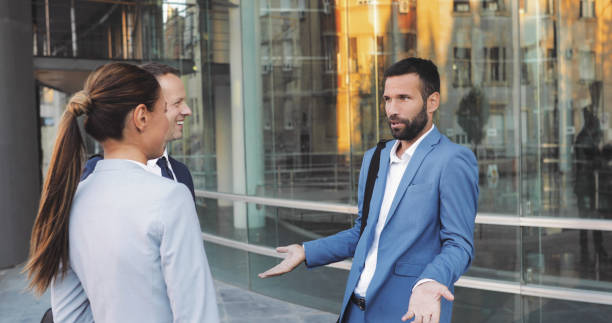 istock Three business colleagues having discussion while walking outdoors 1053347132