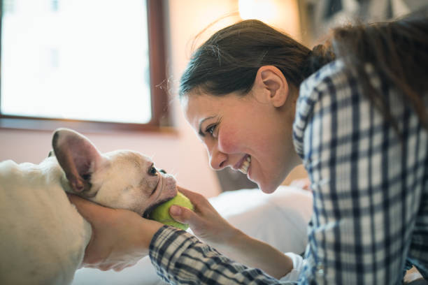 Young women playing with her dog