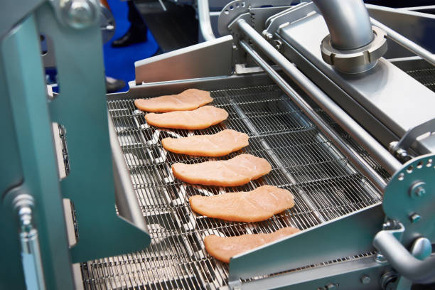 istock Pieces of meat in machine dry breading 1053353980