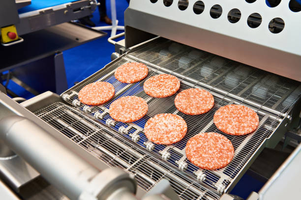 istock Pieces of minced meat in machine wet breading 1053354004