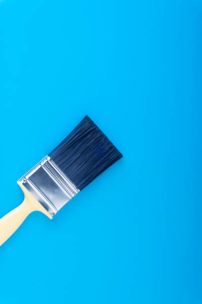 istock Paint brush on blue colour background 1053354990