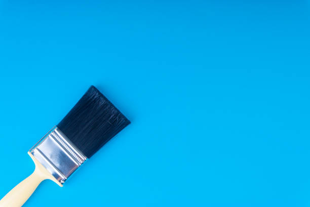 istock Paint brush on blue colour background 1053355052