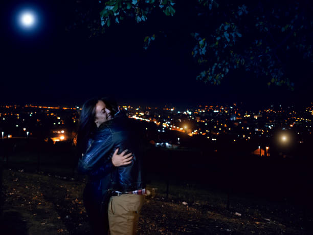 istock Couple hugging with city lights in the background 1053355196