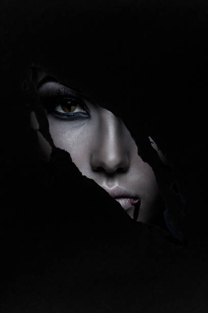 Halloween Spooky woman looking through a hole. Halloween theme. vampire woman stock pictures, royalty-free photos & images