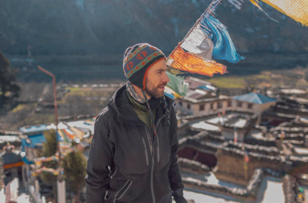istock Young man in the mountains with flags, Nepal 1053356472