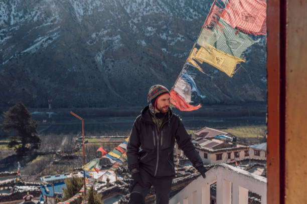 istock Young man in the mountains with flags, Nepal 1053356492