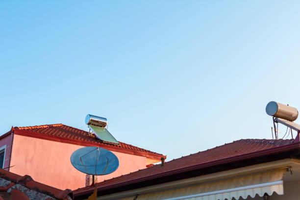 istock Solar panel, water heater on house roof, green energy 1053358046