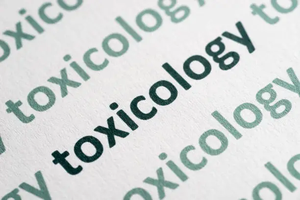 Photo of word toxicology printed on paper macro
