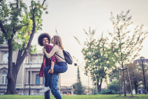 A young loving couple, embracing, piggyback. Caucasian girl and the middle eastern guy