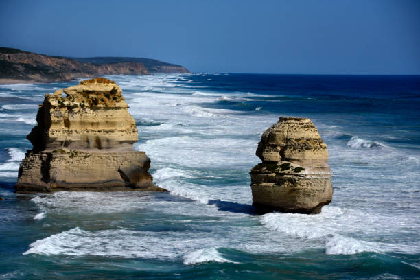 Aerial view of the Twelve Apostles limestone stacks along the Great Ocean Road, Victoria, Australia, captured from a scenic helicopter flight over the rugged coastline.
