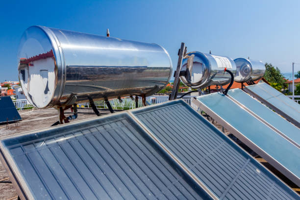 istock Solar panel, water heater on house roof, green energy 1053360496