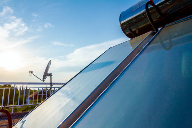 istock Solar panel, water heater on house roof, green energy 1053364082