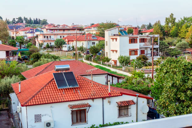 Water panels for using renewable sun energy are placed on house roof, solar hot water system. Modern energy saving technology