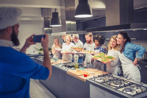 istock Chef is photographing attendees of cooking class 1053372862