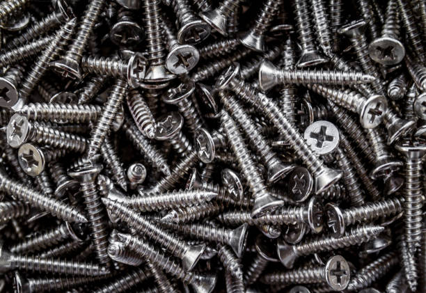 istock Closeup of steel screws background 1053373548