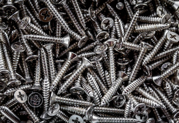 istock Closeup of steel screws background 1053373582