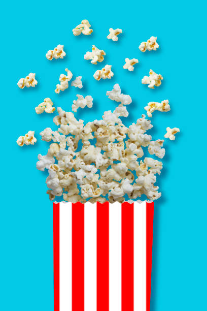 istock Popcorn - Flat lay of popcorn cup on a blue background with clipping path 1053376522