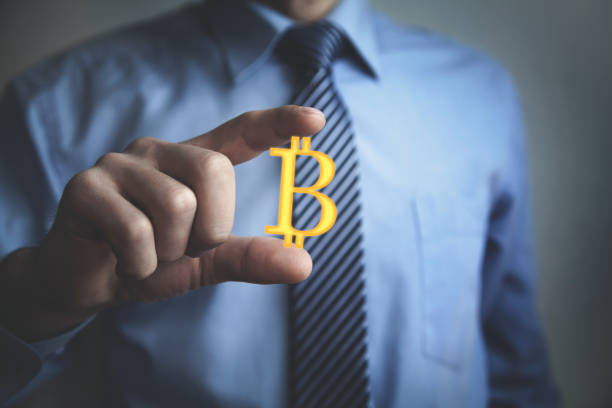istock Businessman showing Bitcoin symbol. Business concept 1053376652