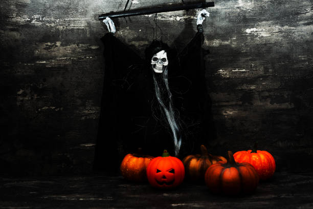 istock Halloween concept with a pumpkin and skeleton on background 1053381940