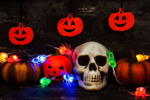 istock Halloween concept with a pumpkin and skeleton on background 1053381968