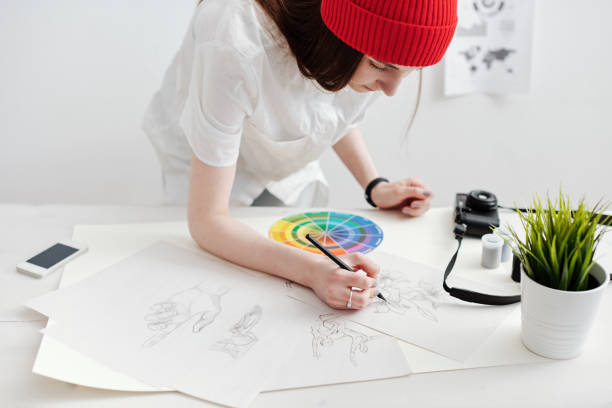 istock Woman drawing sketches 1053382996