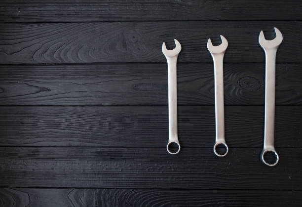 istock Spanners or adjustable wrenches on black wooden background 1053385242