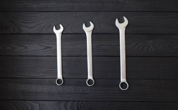 istock Spanners or adjustable wrenches on black wooden background 1053385276