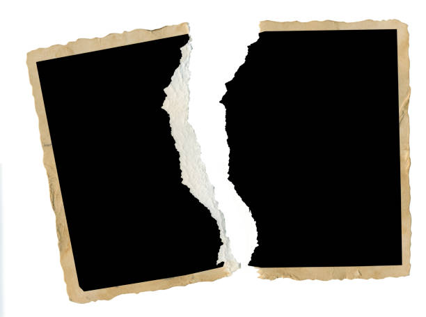 istock torn old empty photograph, photo frame, isolated 1053389658
