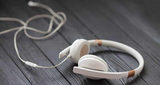 istock Headphones on a black wooden background 1053389916
