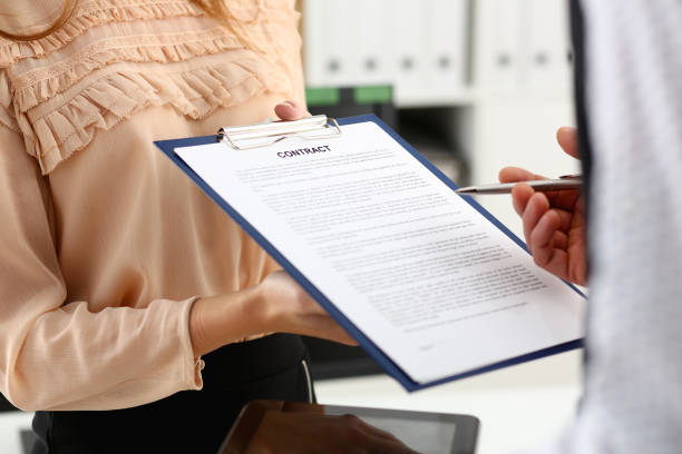 istock Smiling woman offer contract form 1053393070