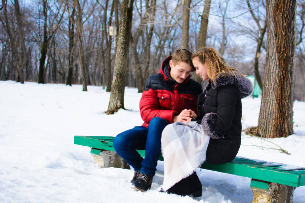 istock loving young couple in winter in park 1053398886