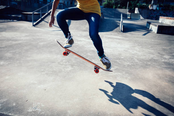 istock Skateboarder doing ollie at skatepark ramp 1053400732