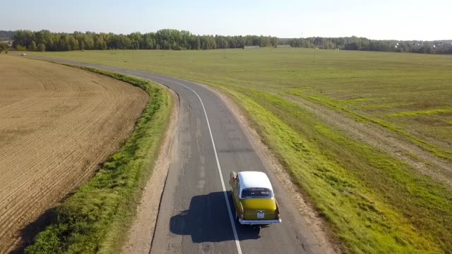 Drone shot vehicle traveling road.
