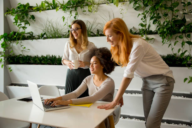 istock Cheerful professional multiracial women working in modern office 1053403806