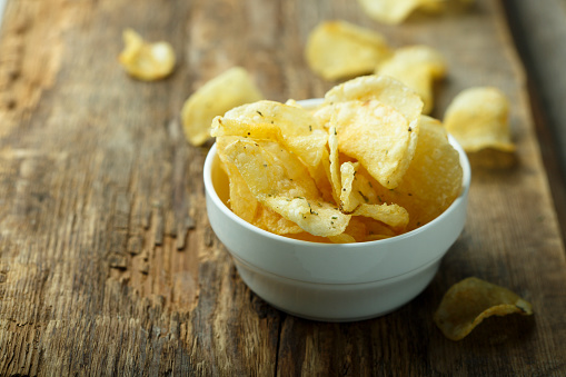 Indian style deep fried chips on white background. It is an Indian Fasting or Vrat food consumed during Navratri, Ekadashi or Ganesh chaturthi. as a snack for fasting in Hindu culture