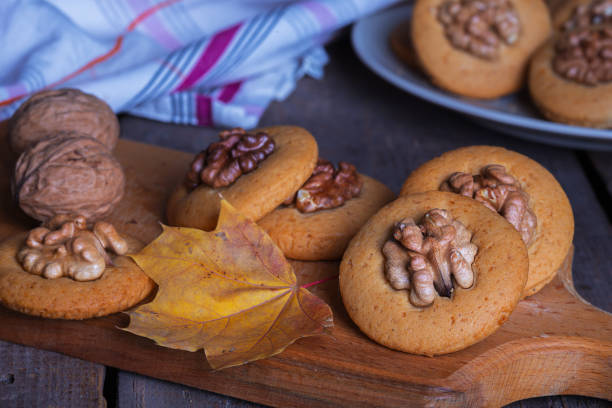 istock gingerbread cookies with walnuts on a table and a cup of milk 1053407610