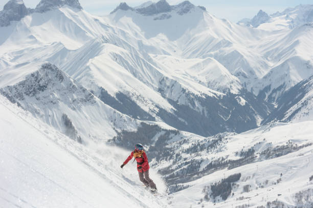 istock Woman snowboarding in fresh powder snow 1053409024