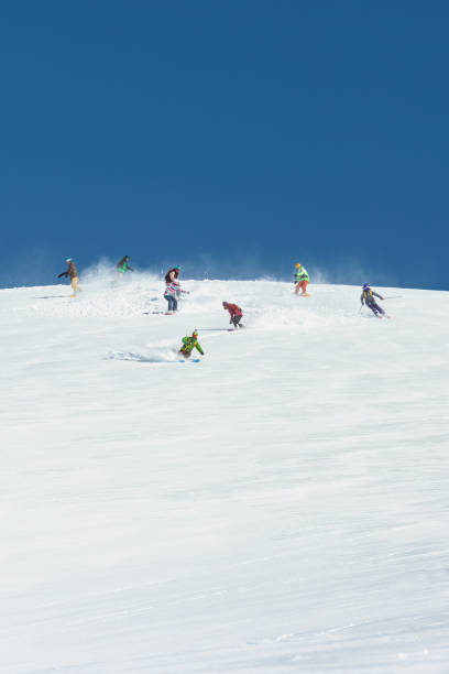 istock Friends skiing down the ski slope together 1053409090