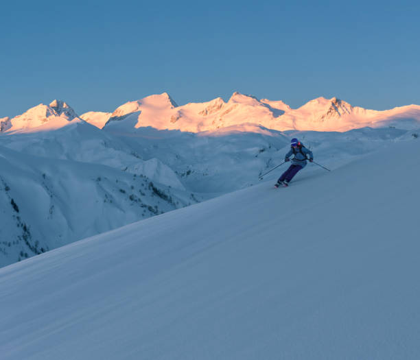 istock Female skier skiing at sunrise 1053409532