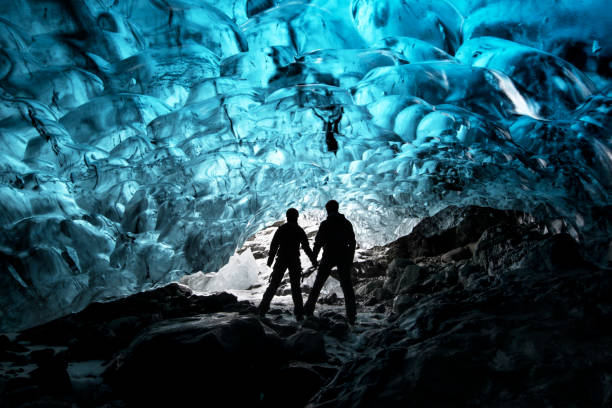 istock Silhouette of couple inside glacial cave 1053410344