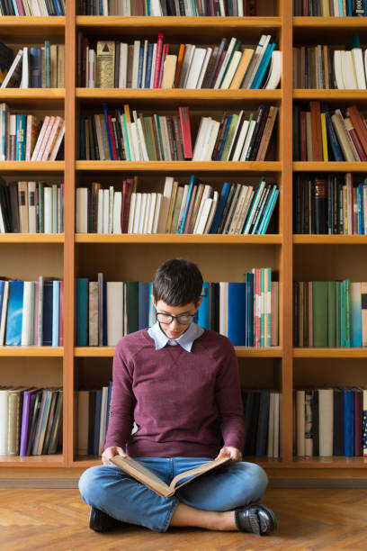 istock Woman studying in the library 1053412424