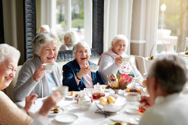 There's nothing like a good old tea party! Cropped shot of a group of seniors having tea in their retirement home assisted living stock pictures, royalty-free photos & images