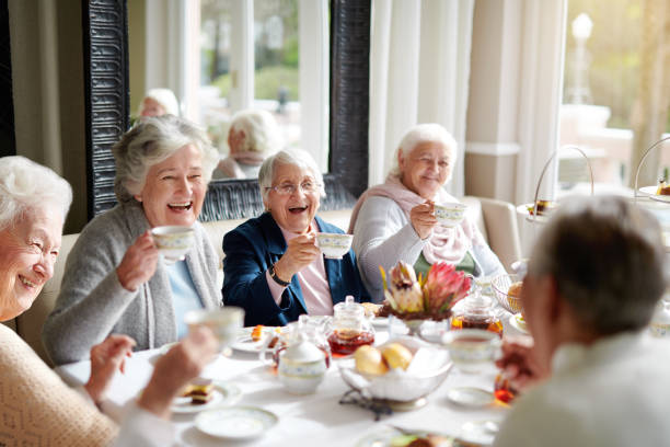 There's nothing like a good old tea party! Cropped shot of a group of seniors having tea in their retirement home ladies lunch stock pictures, royalty-free photos & images