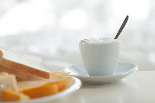 Assorted breads and a cup of coffee isolated on white background
