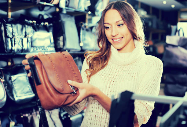 istock Ordinary female choosing bag among assortment 1053417278