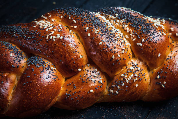 istock Fresh homemade bun with poppy seeds, with ingridients on dark rustik background. Copy space for text, brand or logo. 1053417964